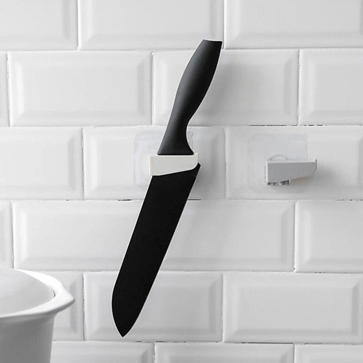 Punch free knife holder from Superior eMart holding a black kitchen knife on a tiled wall