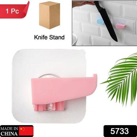 Punch free knife holder in pink with adhesive backing for easy installation on kitchen walls