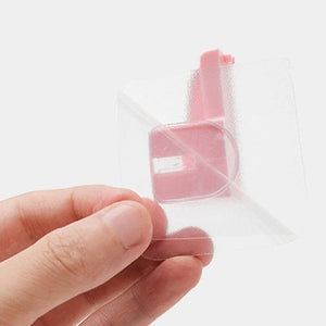 Hand holding a clear punch free knife holder designed for easy storage in kitchens