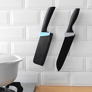 Innovative punch free knife holder in use, securely holding two kitchen knives on a wall