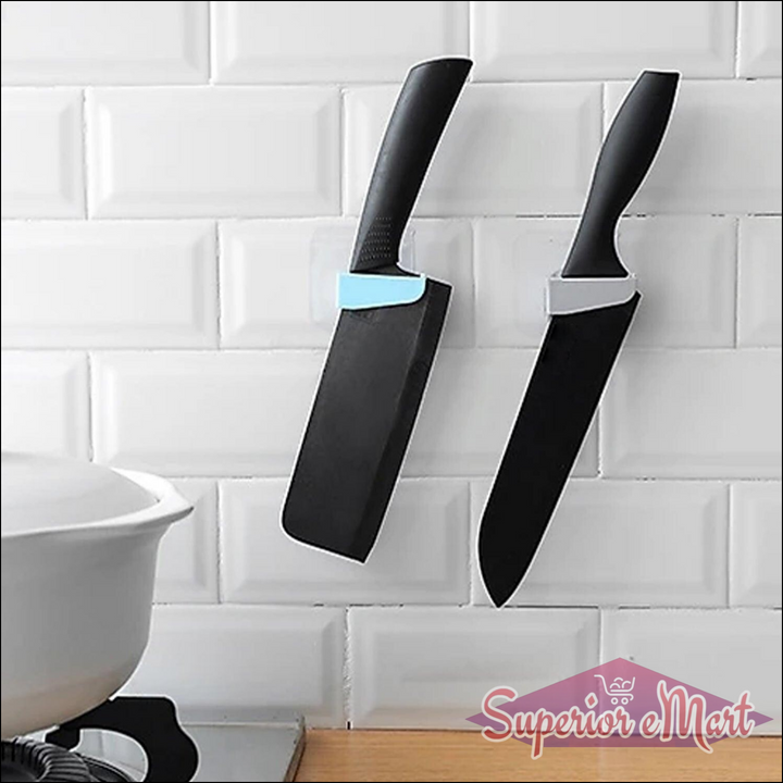 Innovative punch free knife holder in use, securely holding two kitchen knives on a wall