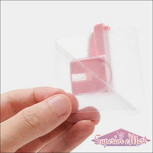 Hand holding a clear punch free knife holder designed for easy storage in kitchens