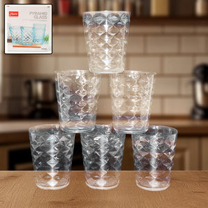 Set of six pyramid design unbreakable glass tumblers stacked on a kitchen counter