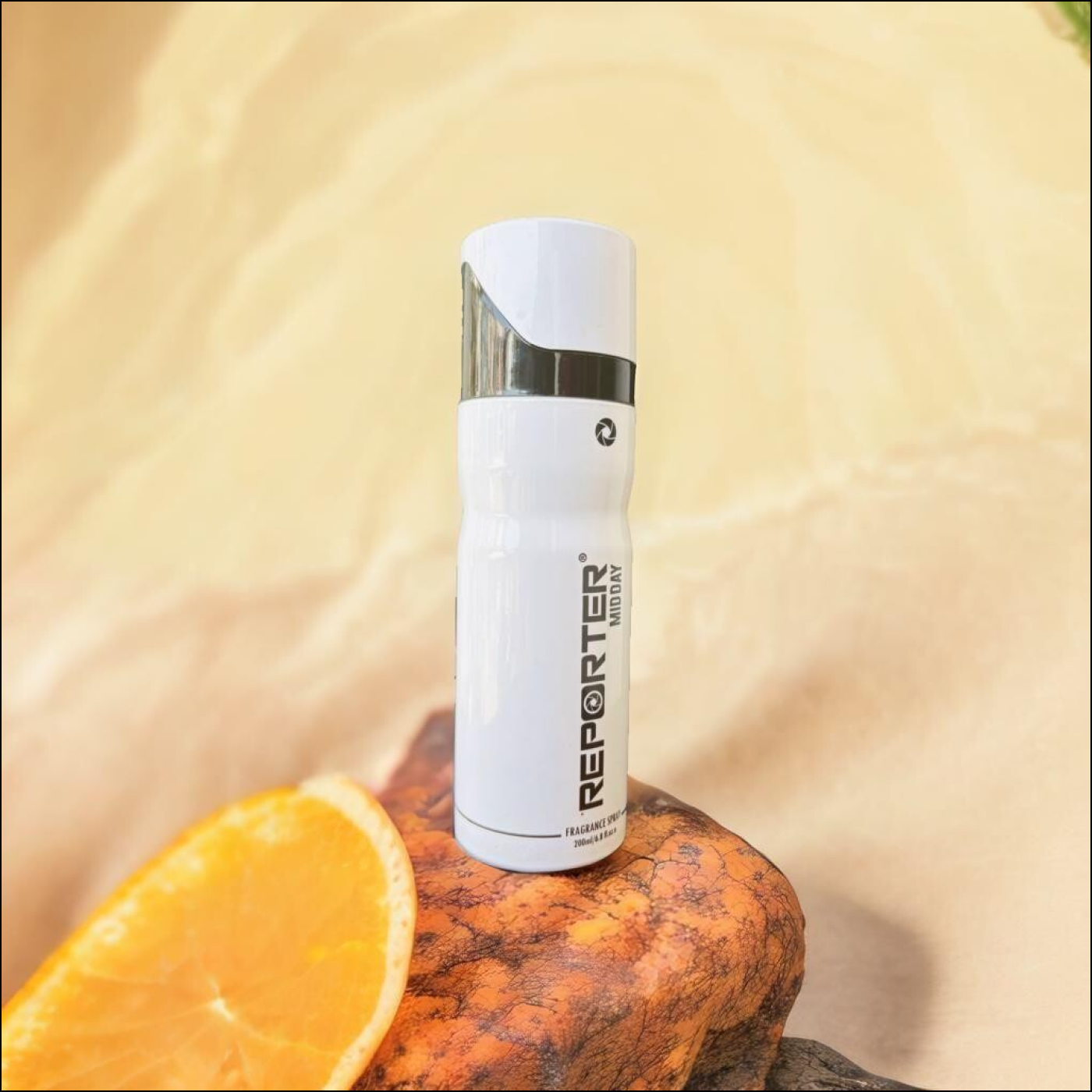 Reporter Midday Fragrance Spray 200ml on a wooden surface next to a fresh orange slice