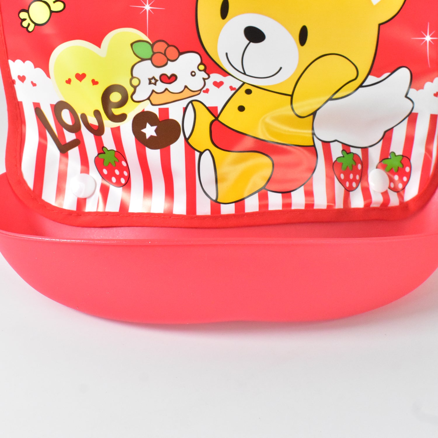 Brightly colored reusable baby bibs featuring a cute bear design and strawberry patterns for easy feeding