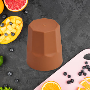Brown reusable drinking cup 1 pc on a kitchen counter surrounded by fresh fruits