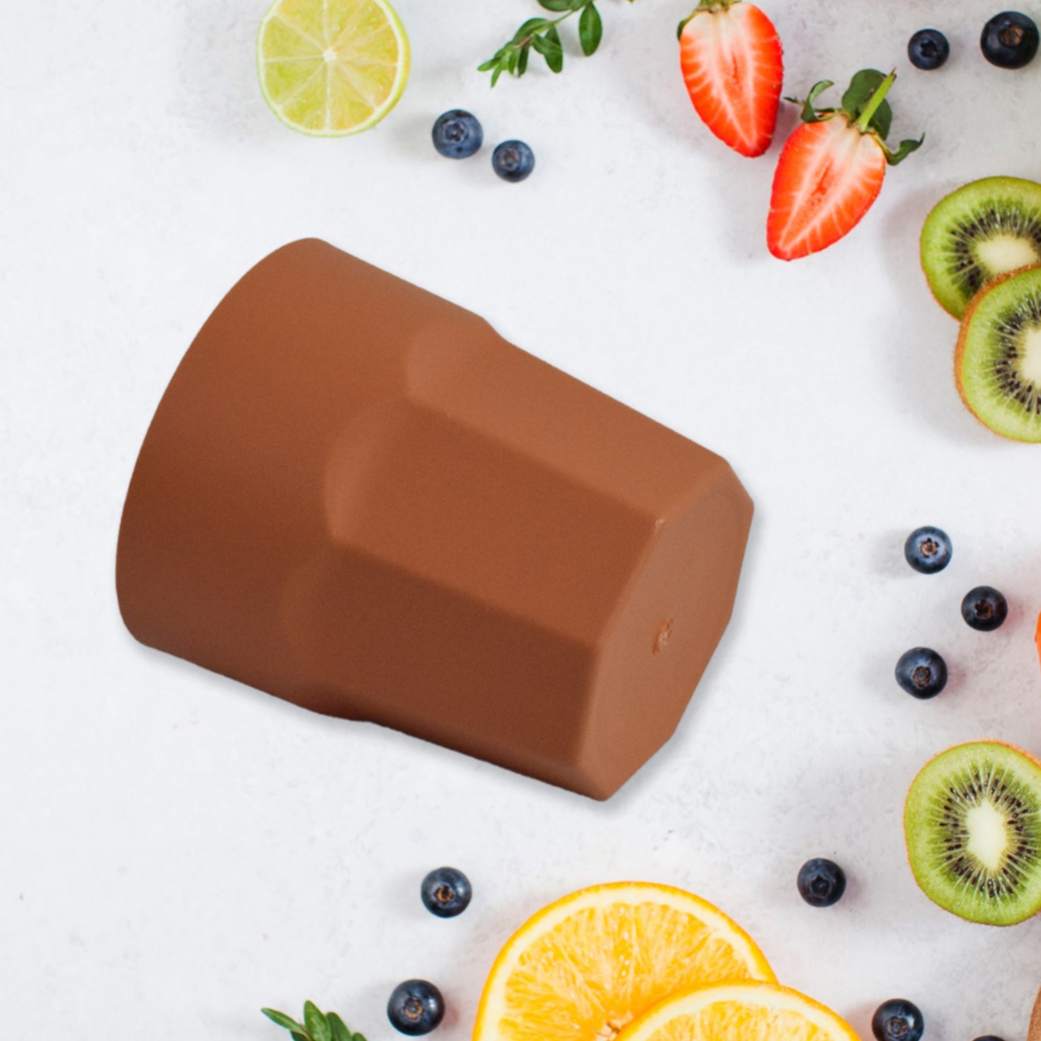 Brown reusable drinking cups 1 pc on a table with fresh fruits like strawberries and oranges