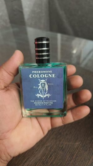 Men's pheromone cologne in a stylish bottle held in a hand for attracting confidence and charisma