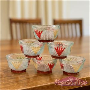 Rose glass dessert bowl set stacked on a wooden table, featuring colorful floral designs