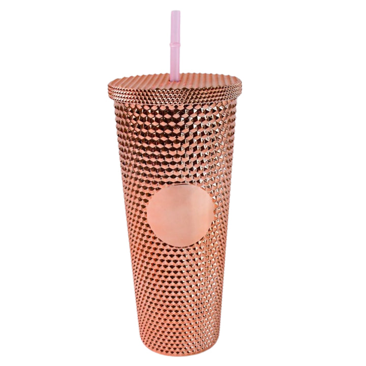 Copper colored studded tumbler with straw featuring textured design for home and kitchen use