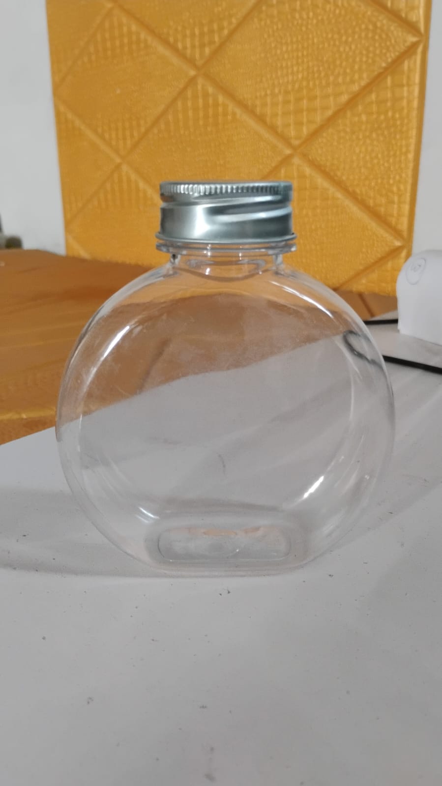 Round clear storage container with silver screw-on lid for kitchen and home organization