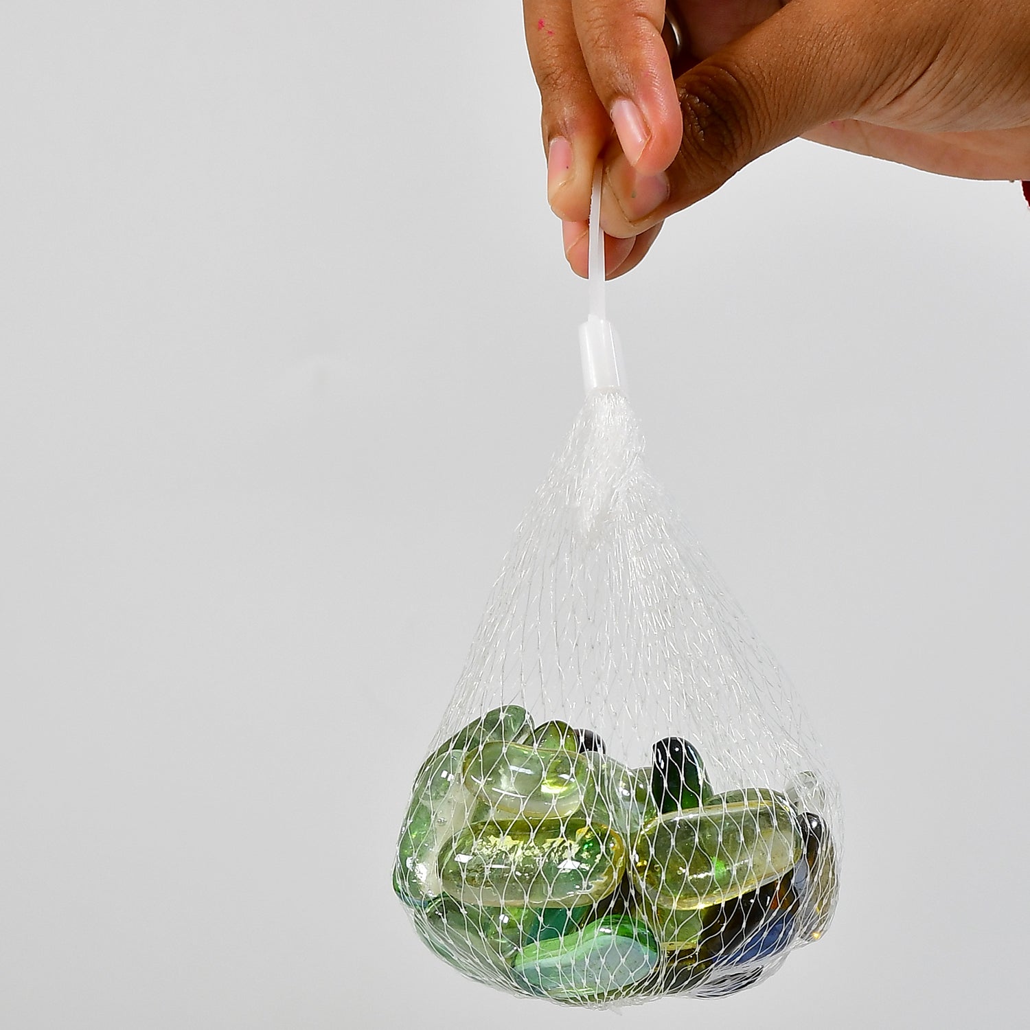 Net bag of colorful round marbles for aquarium decoration and landscaping