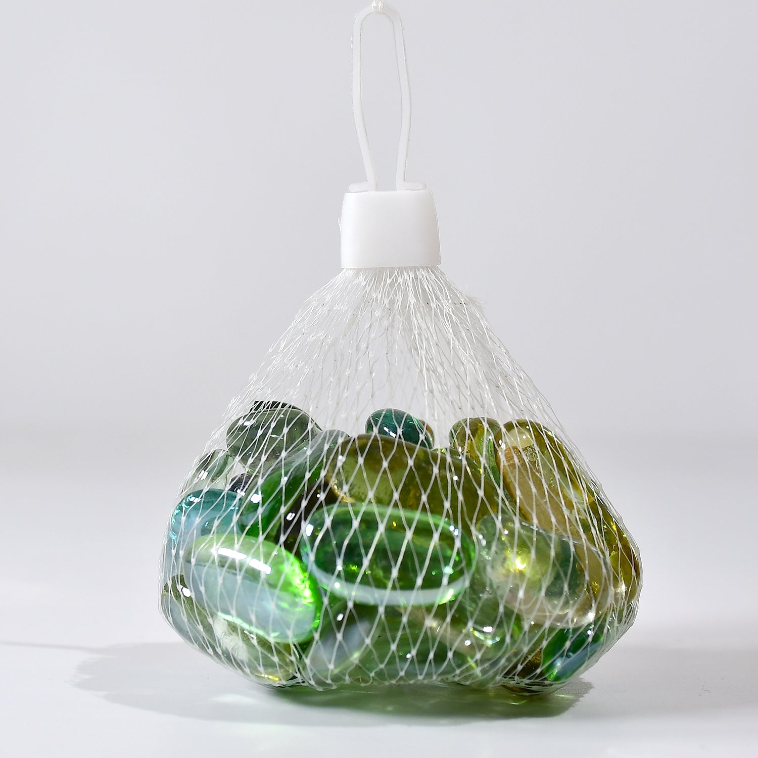 Pack of round marbles for aquarium in a mesh bag, perfect for decorative aquascapes