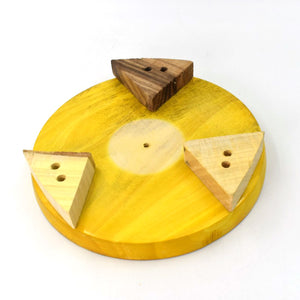 Round roti maker for home use with a wooden base and triangle-shaped handles for easy pressing