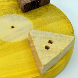 Wooden surface of a round roti maker for home use with triangle and square components