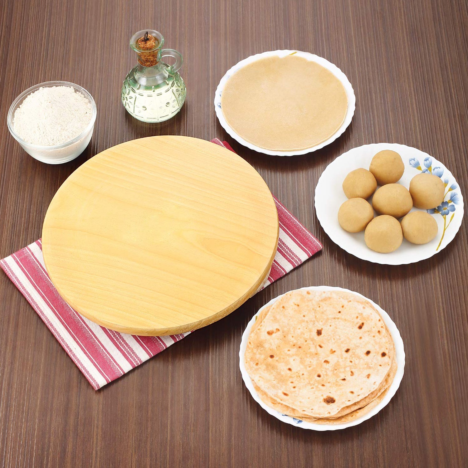 Round roti maker for home use with ingredients including flour, dough balls, and prepared rotis