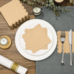 Scalloped edge disposable napkins packaged neatly on a dining table setting with tableware