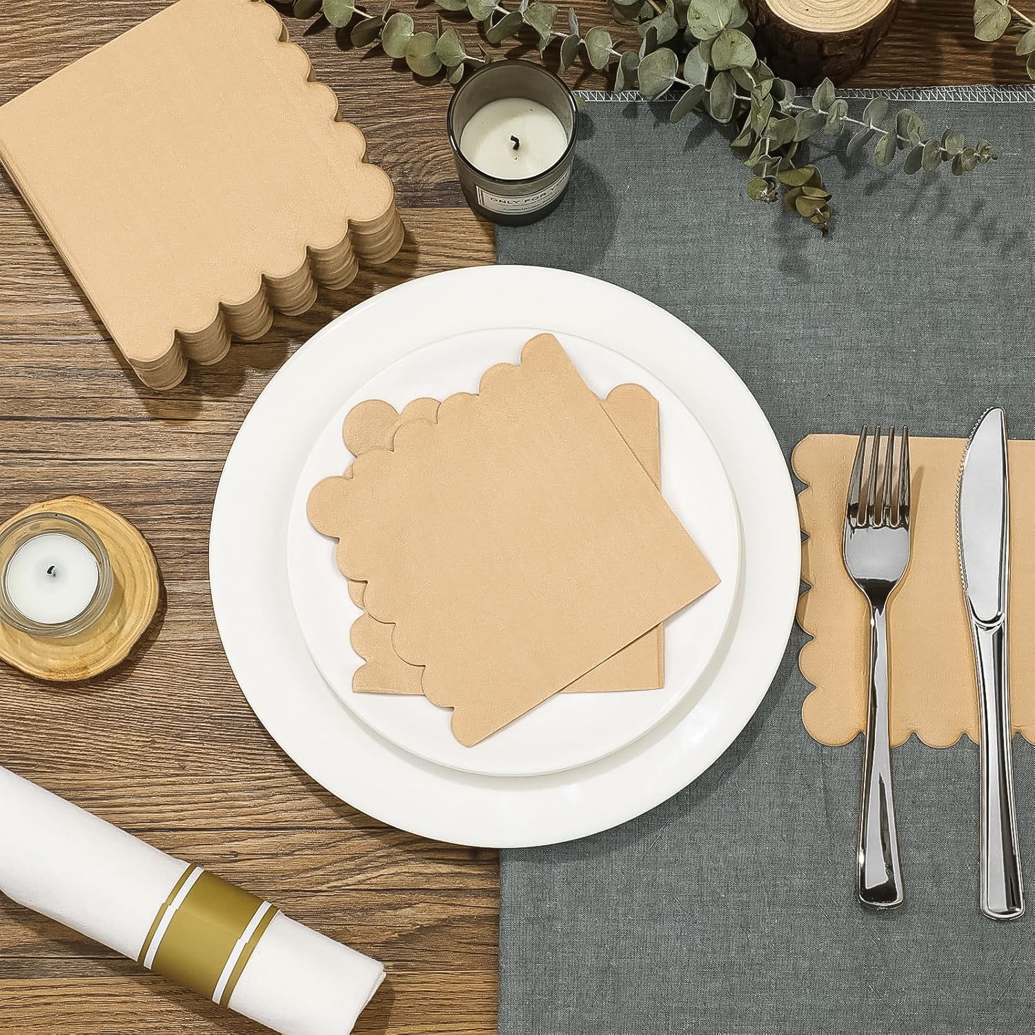 Scalloped edge disposable napkins packaged neatly on a dining table setting with tableware
