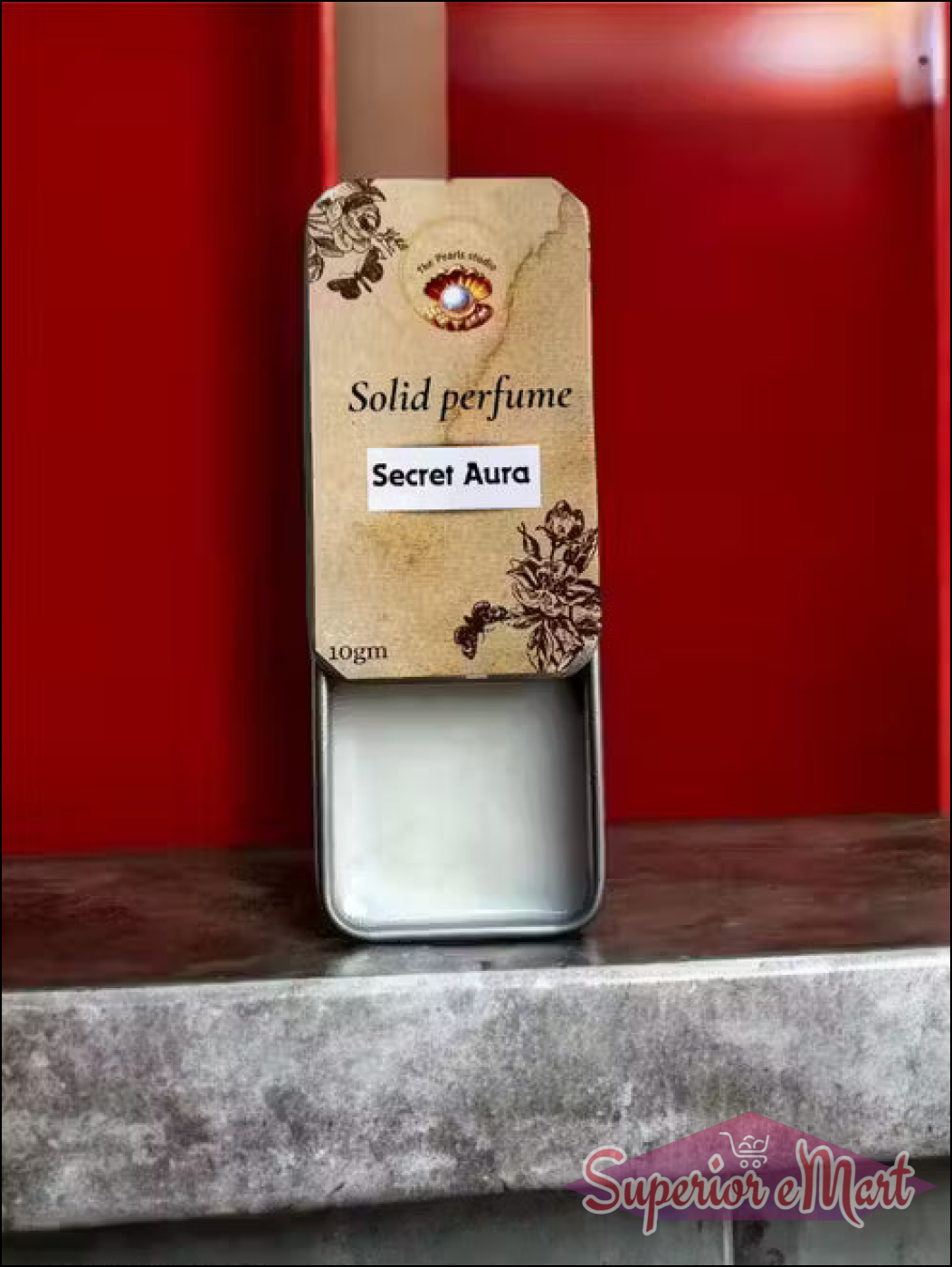 10gm Secret Aura solid perfume in a sliding metal tin with a vintage floral beige label and white balm.