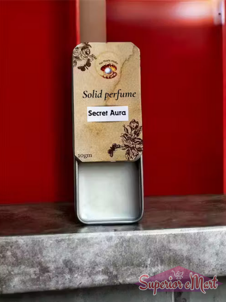 10gm Secret Aura solid perfume in a sliding metal tin with a vintage floral beige label and white balm.