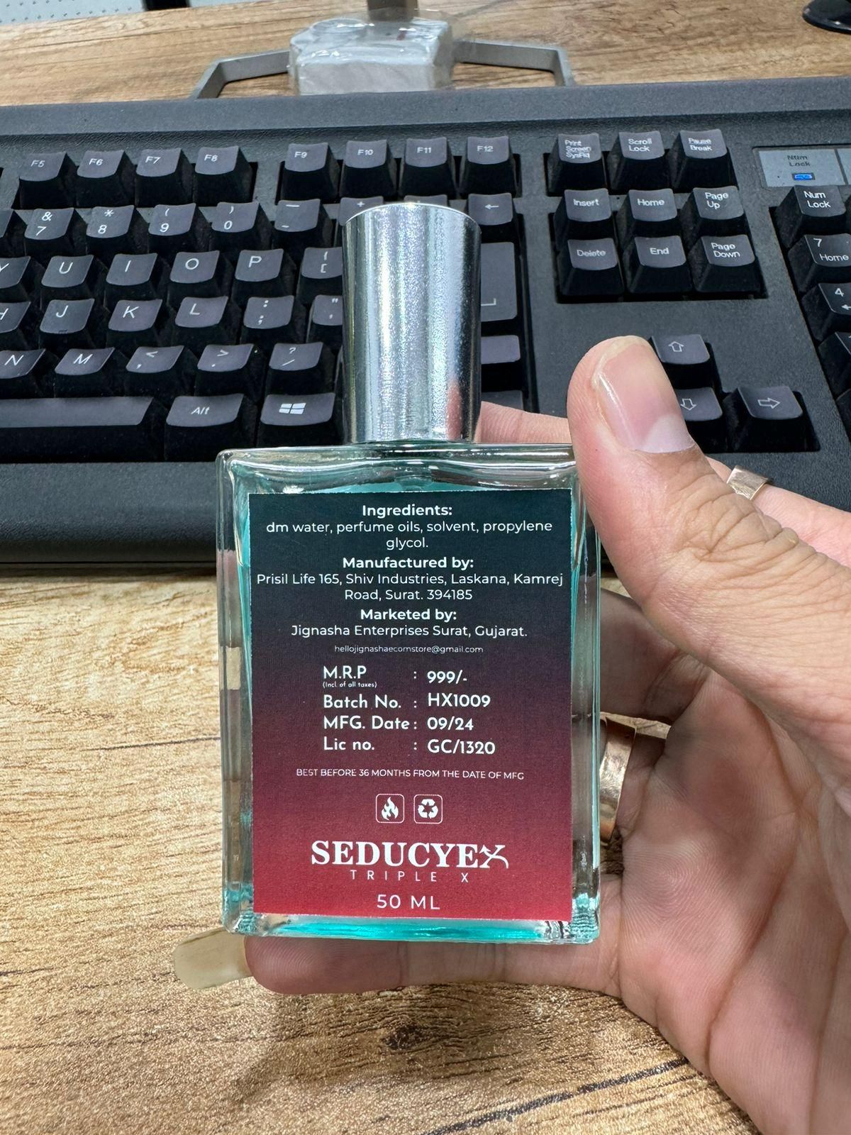 Seducye Triplex extrait de parfum 50ml bottle showing label and ingredients held in hand
