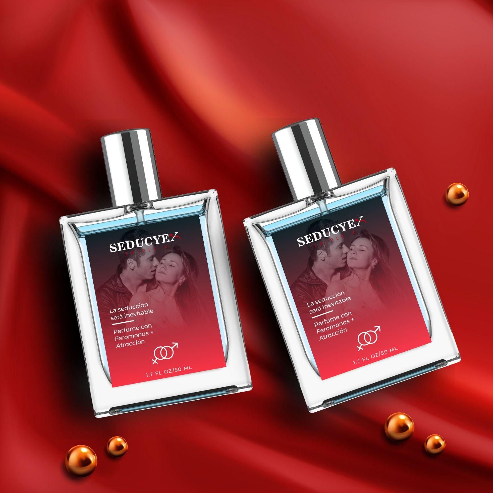 Two Seducye Triplex extrait de parfum bottles with silver caps on red satin fabric background