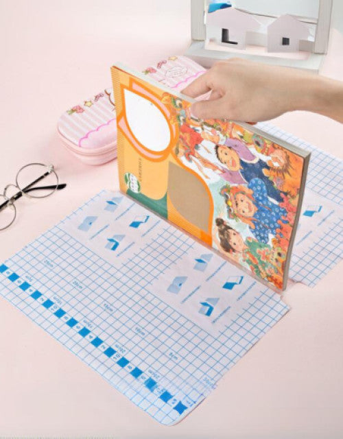 Hand applying self-adhesive transparent protective book cover on a colorful children's book
