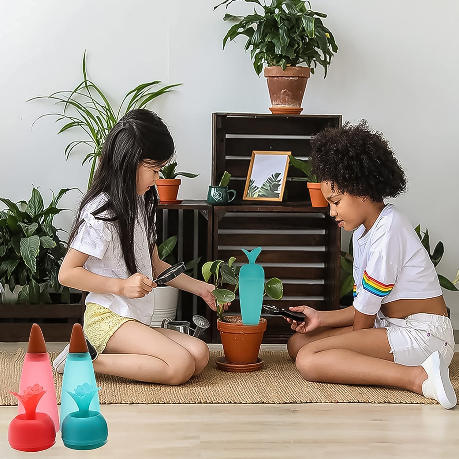 Two children using self watering plant spikes 1 Pc to care for potted plants indoors