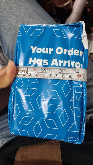 Blue shipping package for long-lasting cologne for men from Superior eMart with measuring tape for size reference