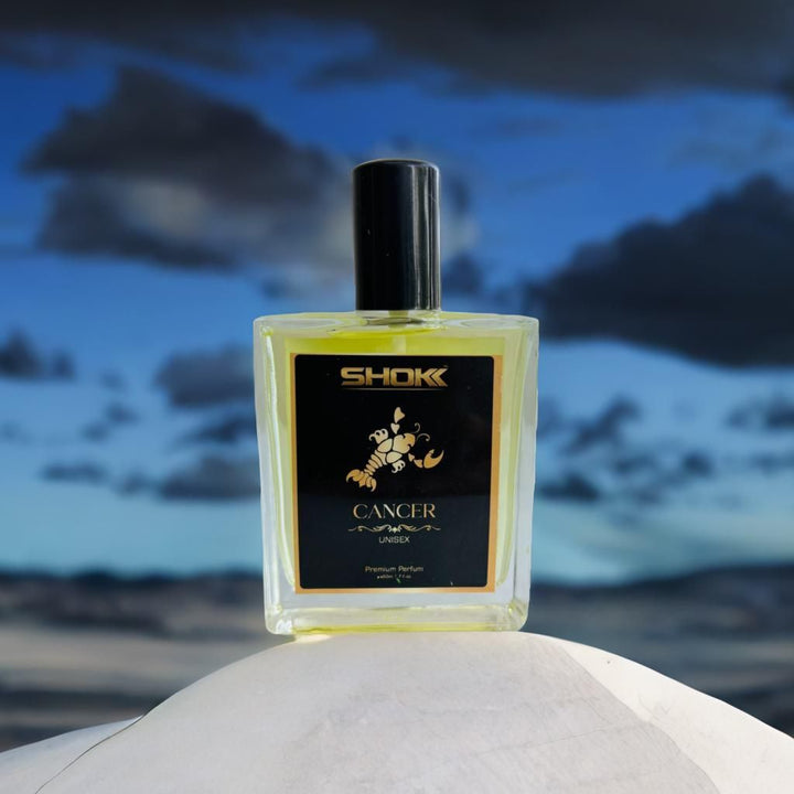 Cancer Zodiac Unisex Perfum 50ml by Superior eMart in clear glass bottle with black cap against sky background