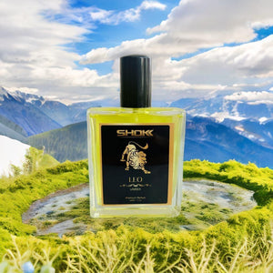 Leo zodiac unisex perfume 50ml bottle displayed in a scenic mountain landscape