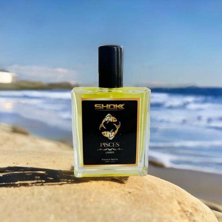 Pisces zodiac unisex perfume 50ml by Superior eMart in clear bottle with black cap on a beach background