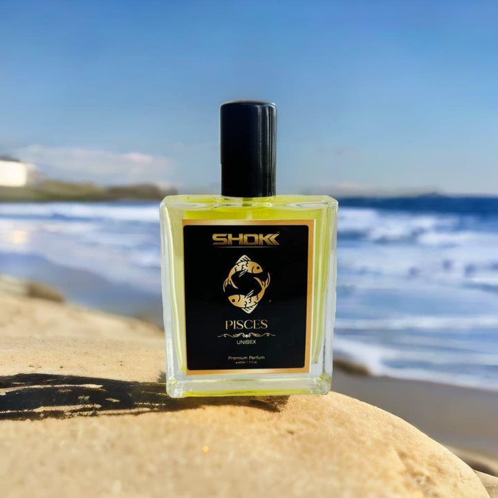 SHOK Pisces zodiac unisex perfume 50ml on a beach, perfect for aquatic scent lovers