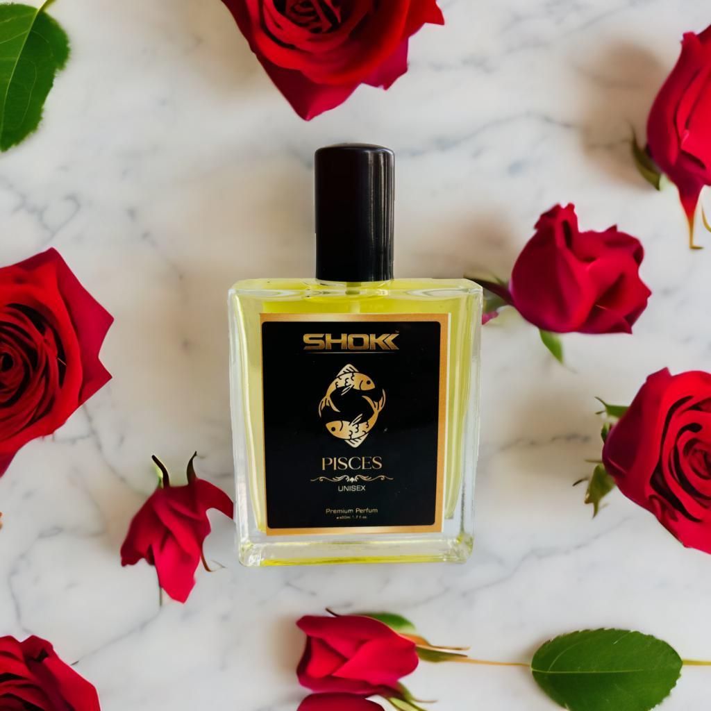 Pisces zodiac unisex perfume 50ml bottle with black label and gold design surrounded by red rose petals