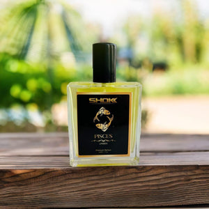 Pisces zodiac unisex perfume 50ml bottle on a wooden table with a blurred garden backdrop