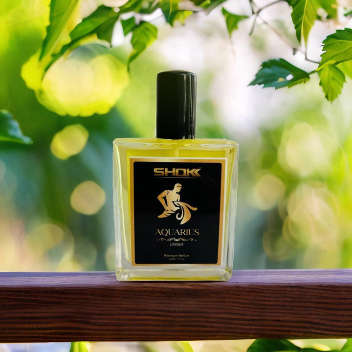 Aquarius Zodiac Unisex Perfum 50ml bottle with black cap and gold label on wooden surface outdoors