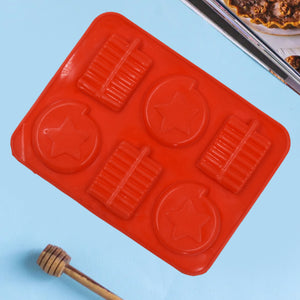 Silicone chocolate mold tray in red with six star-shaped compartments for easy candy making