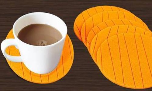 Silicone cup mat coaster set in bright orange, designed to protect surfaces while holding cups