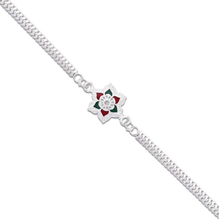 Silver plated rakhi bracelet with floral design and red green accents from Superior eMart