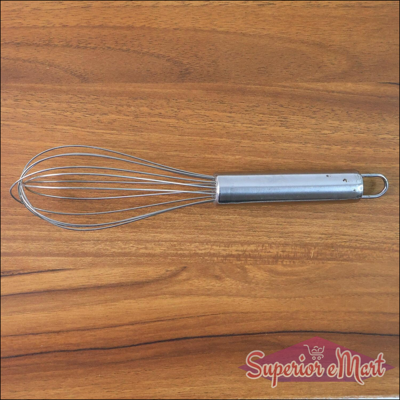 Small stainless steel balloon whisk with a sleek handle, ideal for beatings eggs and mixing ingredients