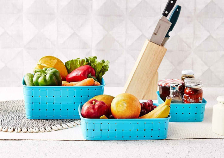 Bright blue smart storage baskets for home filled with fresh fruits and vegetables on a kitchen counter