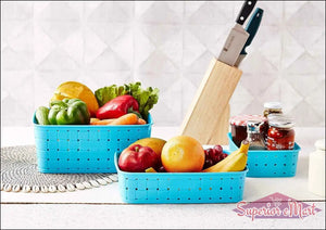 Bright blue smart storage baskets for home filled with fresh fruits and vegetables on a kitchen counter