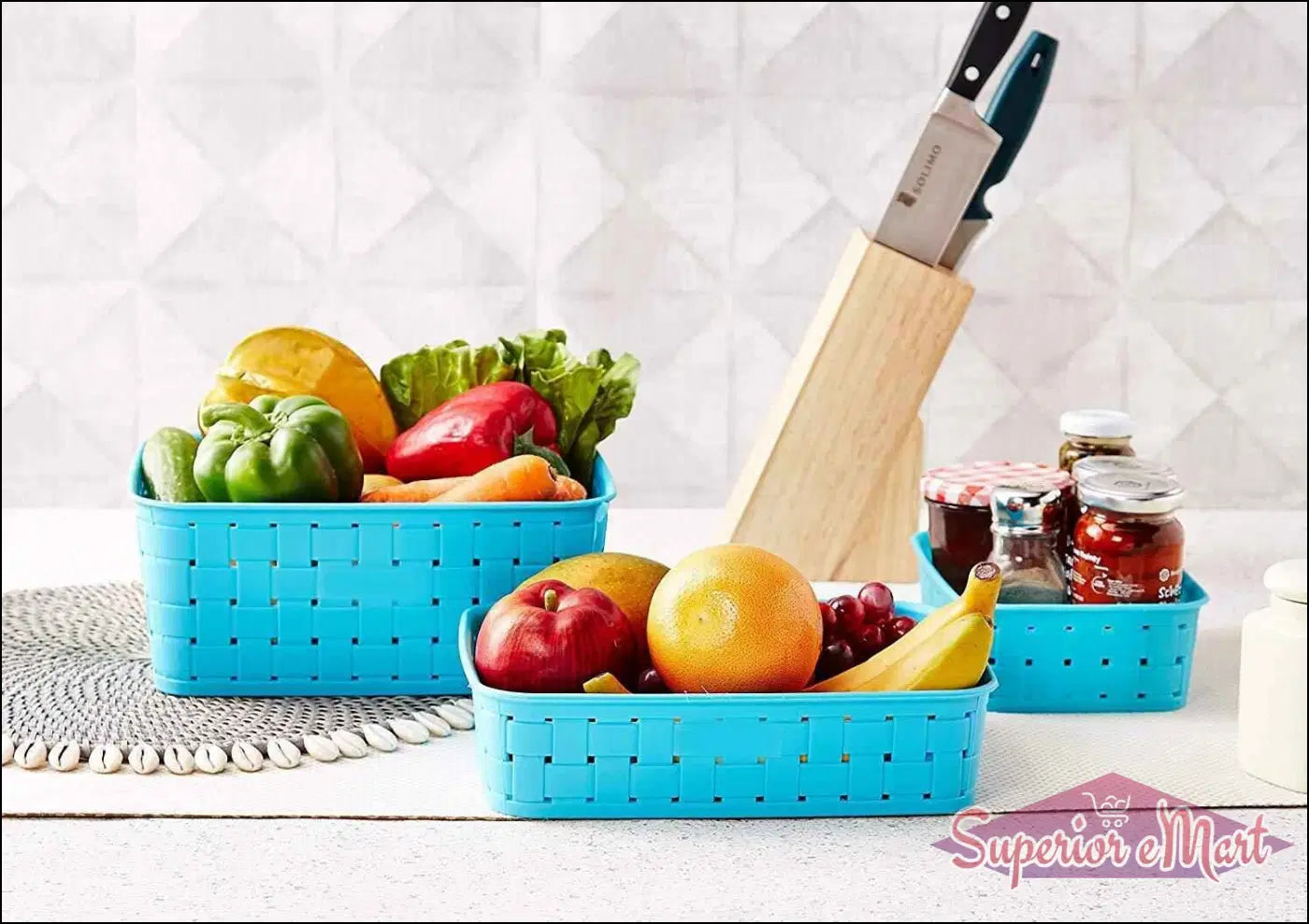 Bright blue smart storage baskets for home filled with fresh fruits and vegetables on a kitchen counter