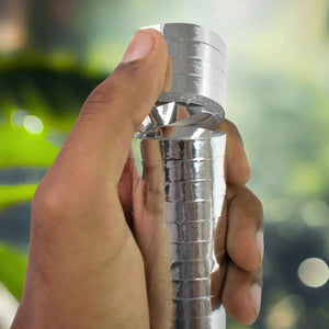 Hand holding smooth ribbon for decorations in shiny silver finish for event styling