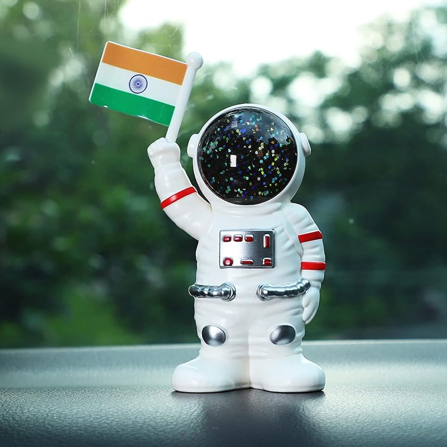 Solar power astronaut ornament holding an Indian flag with a sparkling galaxy helmet, perfect for home decor