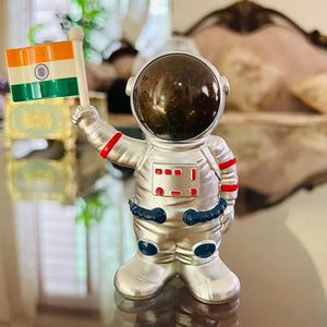 Solar power astronaut ornament holding an Indian flag, perfect for unique home decor