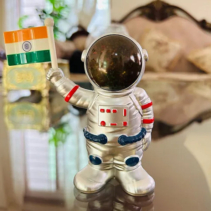 Solar power astronaut ornament holding an Indian flag, perfect for unique home decor