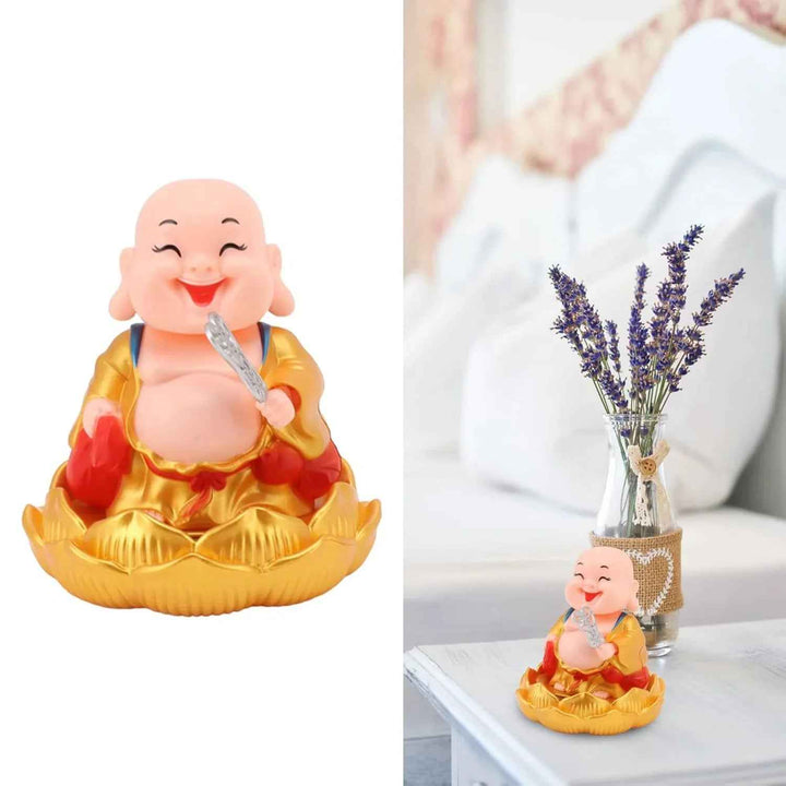 Colorful solar powered Buddha statue on a bedside table with lavender in a vase