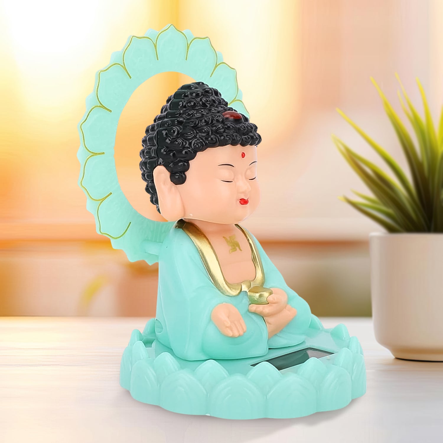 Moving head Buddha ornament in mint green with detailed features for serene home decor
