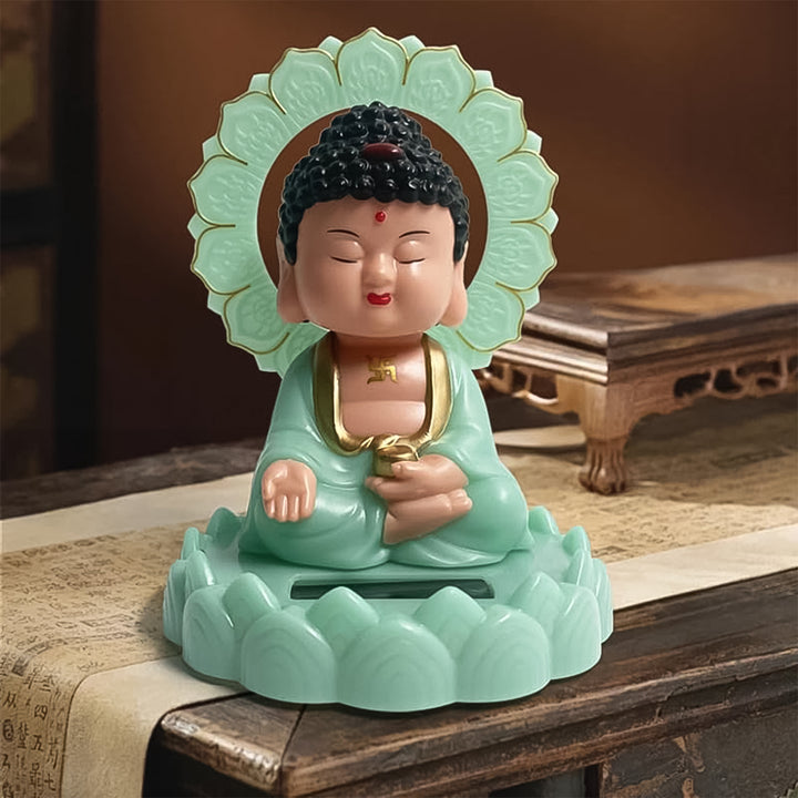 Moving head Buddha ornament in mint green, seated with intricate details and a serene expression